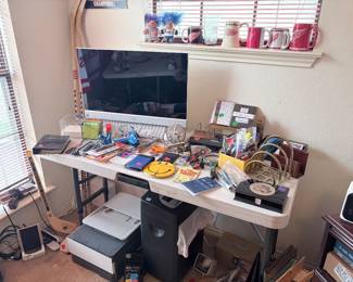 Dell computer, desk accessories, office supplies, hockey sticks