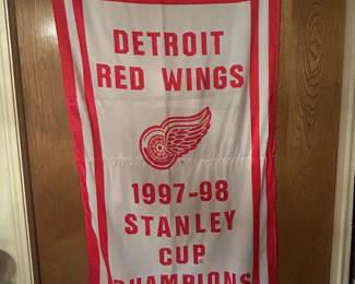 Huge variety of Detroit Red Wings memorbelia - vintage Stanley cup flag; more pictures to follow (table, pillows, jackets, pucks, skates - you name it, we have it!)