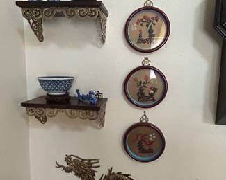 Wood and brass display shelves, brass wall hangings, framed Asian coral art