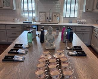 Kitchen island with coffee mugs and travel bottle collection