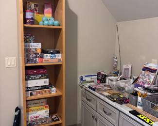 Tall bookshelf filled with board games collection