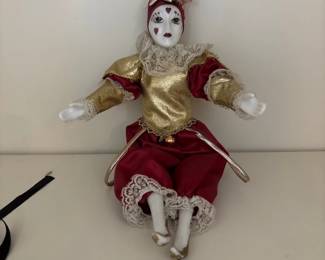 Porcelain Harlequin jester doll in red and gold costume