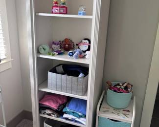 Tall white bookcase with storage bins