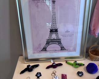 Eiffel Tower print with collection of keychains and trinkets