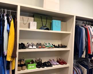 Walk-in closet with organized women's shoes and clothing