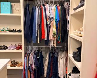 Walk-in closet full of women's clothing and shoes