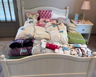 White cottage-style full bed frame with stuffed animals collection