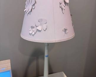 Pink table lamp with 3D floral cutout shade, side view