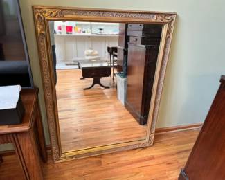 Vintage Beveled Wall Mirror Featuring a Carved Wooden Gold Gilt Frame