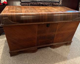 Cavalier cedar chests were primarily produced between 1923 and the 1950s by the Cavalier Corporation in Chattanooga, Tennessee, a company with roots dating back to 1865. Renowned as "hope chests" for storing bridal linens, these chests featured red cedar interiors, often with mahogany or walnut exteriors in Waterfall or Art Deco styles