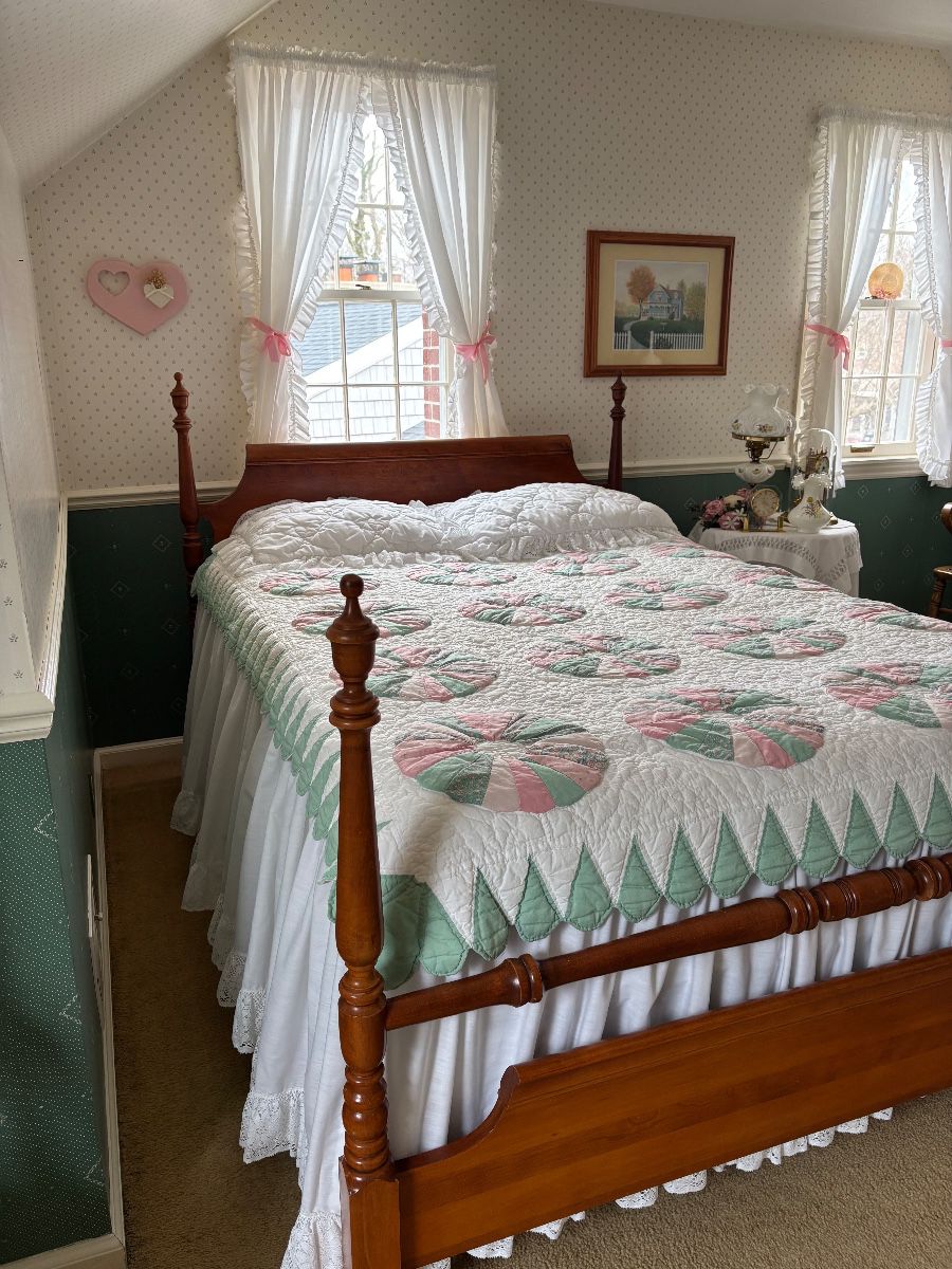 Full-size bed with mattress and box spring.