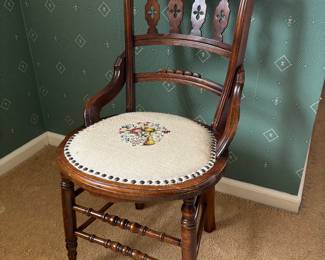 Antique side chair with floral needlepoint seat.