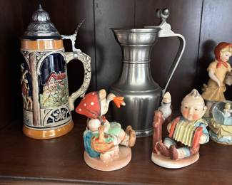 Vintage steins and Hummel figurines.