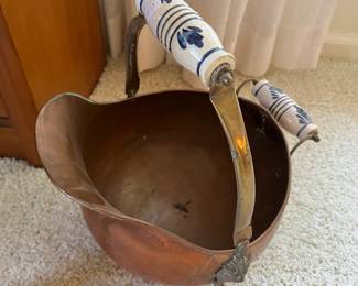 Vintage copper and brass coal scuttle with Delft blue and white porcelain handles.