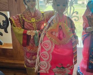 Vintage handmade Asian folk art dolls in traditional costumes.