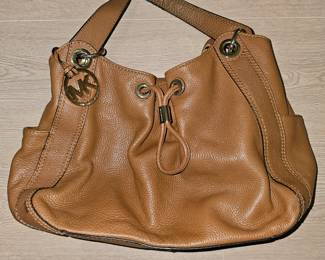 A brown pebbled leather Michael Kors drawstring satchel handbag