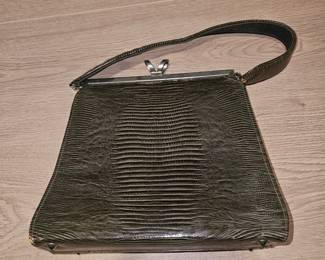 Vintage lizard-patterned leather handbag with metal clasp and top handle.