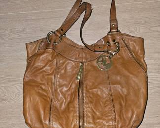 A brown leather Michael Kors shoulder bag with gold-tone hardware and logo charm.