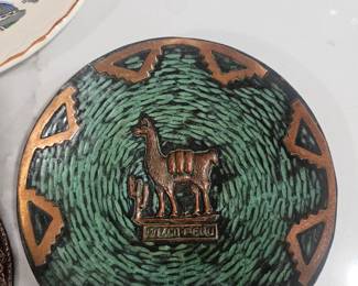 Decorative metal plate featuring a llama and cactus, inscribed "Cuzco-Peru".