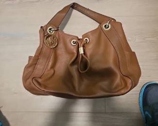 A brown pebbled leather Michael Kors drawstring satchel handbag