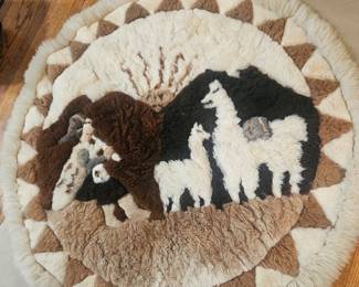 Handmade Skin circular wool rug with llama and figure motif