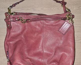 A used magenta pebbled leather Coach Brooke hobo shoulder bag.