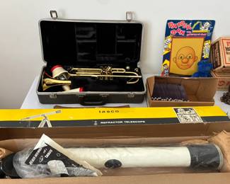 Vintage trumpet, telescope, and toys