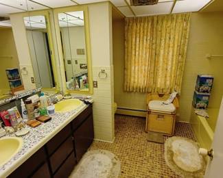 Precious yellow mosaic bathroom holds all kinds of fun items!