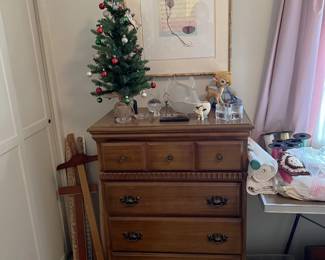 There are framed art pieces here, along with this nice dresser and miniature Christmas tree.