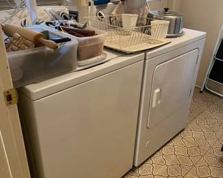 Underneath the miscellaneous kitchen equipment is a washer and dryer combination.