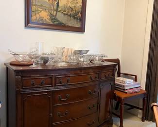 While this cabinet is currently more of a credenza or buffet table, you can use it however you like.  There are several crystal serving dishes and a calm country lane in the picture.