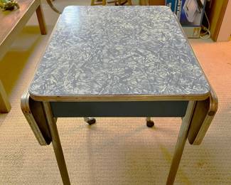 This table with two fold-down leaves is from Virtue Bros of California, and is in excellent shape.