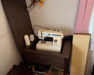 This is the consumer Kenmore sewing machine and sewing cabinet.  The white rectangle is a sewing layout board.