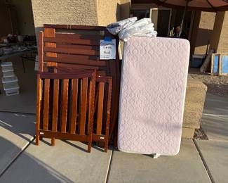 A crib which converts to a bed and the mattress