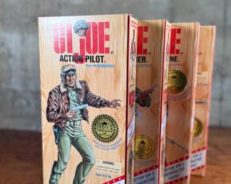 Five limited edition G.I. Joe WWII commemorative figures by Hasbro, including Action Soldier, Action Sailor, Action Marine, Action Pilot, and Dress Marine. Each figure is in its original themed packaging with accessories depicted on the box art. All packaging shows detailed design and preservation of classic military themes.