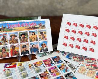 Unused United States postage stamps with a face value exceeding $50. The collection features various designs, including “Legends of the West” and other themed sheets depicting notable individuals, symbols, and events. All stamps are in original condition, ideal for collectors or practical use.