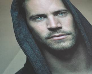 This lot features a signed limited edition print of Paul Walker by renowned photographer, Patrick Hoelck. Measures, 36” H x 30” W.