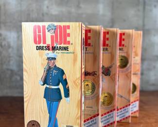 Five limited edition G.I. Joe WWII commemorative figures by Hasbro, including Action Soldier, Action Sailor, Action Marine, Action Pilot, and Dress Marine. Each figure is in its original themed packaging with accessories depicted on the box art. All packaging shows detailed design and preservation of classic military themes.
