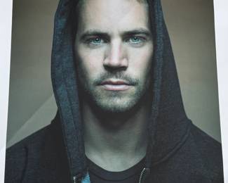 This lot features a signed limited edition print of Paul Walker by renowned photographer, Patrick Hoelck. Measures, 36” H x 30” W.