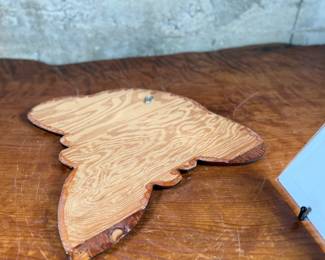 Boston commemorative plaque celebrating the sale of more than one million copies of the LP “Boston.” The design replicates the iconic album cover, featuring a UFO motif with vibrant colors and a mounted metal dedication plate. Includes documentation verifying authenticity. Constructed from wood and metal materials, with visible mounting hardware on the reverse side. Accompanied with a certificate of authenticity.