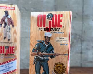 Five limited edition G.I. Joe WWII commemorative figures by Hasbro, including Action Soldier, Action Sailor, Action Marine, Action Pilot, and Dress Marine. Each figure is in its original themed packaging with accessories depicted on the box art. All packaging shows detailed design and preservation of classic military themes.