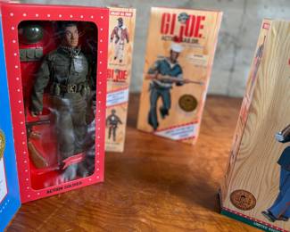 Five limited edition G.I. Joe WWII commemorative figures by Hasbro, including Action Soldier, Action Sailor, Action Marine, Action Pilot, and Dress Marine. Each figure is in its original themed packaging with accessories depicted on the box art. All packaging shows detailed design and preservation of classic military themes.