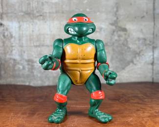 1989 Playmates Toys Teenage Mutant Ninja Turtles action figure representing Michelangelo.