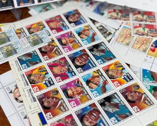 Unused United States postage stamps with a face value exceeding $50. The collection features various designs, including “Legends of the West” and other themed sheets depicting notable individuals, symbols, and events. All stamps are in original condition, ideal for collectors or practical use.