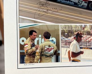 Professionally matted collage of photos featuring Bob Wollek, Jim Busby, & John Andretti. Signed by all three racers, along with master photographer Richard Stefani. Measures in matting, 12.5” H x 14.25” W. Robert Jean Wollek, nicknamed “Brilliant Bob”, was a race car driver from Strasbourg, France. He won a total of 76 races in his career, 71 in Porsche cars, including four editions of the 24 Hours of Daytona and one edition of the 12 Hours of Sebring. John Andrew Andretti was an American professional race car driver. He won individual races in CART, IMSA GTP, Rolex Sports Car Series, and NASCAR during his career.