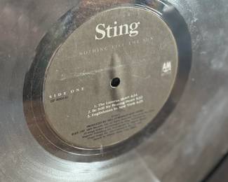 Platinum record plaque for Sting’s ‘Nothing Like the Sun, ’ presented to commemorate significant sales achievements. Features the album’s artwork, a platinum-finish record, and an integrated cassette tape. Measures 19.5” H x 16” W.