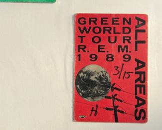 This lot features two (2) vintage All Access passes. The Rush pass features a green design with a rabbit emerging from a hat and is marked ‘APR 6, 1991.’ The R.E.M. pass is a red design from the ‘Green World Tour 1989,’ numbered ‘3/15.’ Both are collectible memorabilia from popular rock bands’ tours.