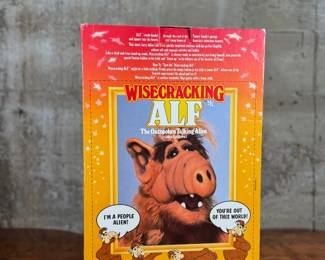 Wisecracking ALF talking plush manufactured by Coleco. Includes phrases activated by pressing the belly. Still housed in the original packaging, marked for ages 4 and up. Box shows some visible wear but is intact, and the toy appears unused.