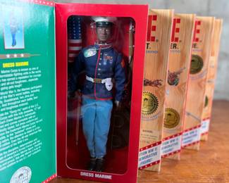 Five limited edition G.I. Joe WWII commemorative figures by Hasbro, including Action Soldier, Action Sailor, Action Marine, Action Pilot, and Dress Marine. Each figure is in its original themed packaging with accessories depicted on the box art. All packaging shows detailed design and preservation of classic military themes.