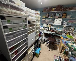 Craft room full of paper items, beading, jewelry making, and more.